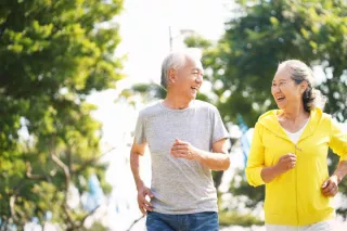 Couple with dialysis cycling on beach as exercise