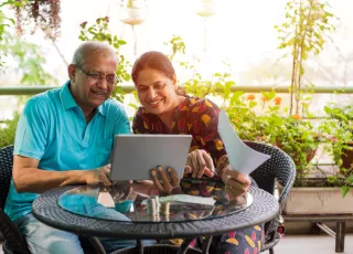 Couple discussing kidney disease treatment options with laptop