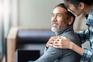Daughter comforting father on dialysis at home