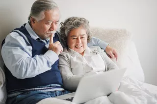 Elderly couple smiling to each other